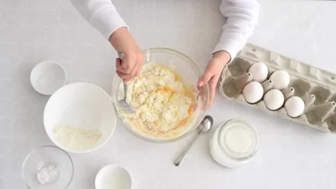 Process of making dough. Small child's hands mix flour and eggs in bowl. Stock Footage 178527226