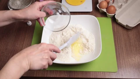 Process of making dough. Woman mixed powdered sugar, almond flour and egg white Stock Footage 287279125