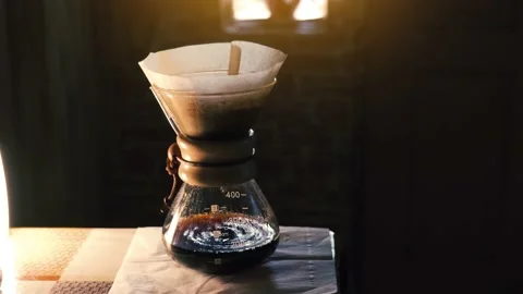 Process of making drip coffee. Brewed black coffee dripping in glass pot Stock Footage 141681499