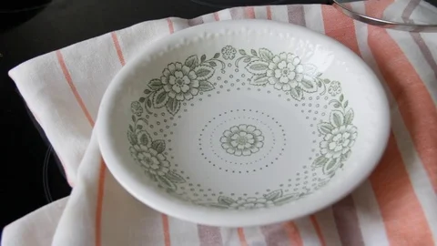 The process of making dumplings. Boiled dumplings are shifted to the plate Stock Footage 72374684