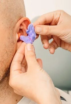 Process of making earplug from an impression of an individual's human ear. Ea Fotos Stock
