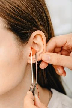 Process of making earplugs from an impression of an individual human ear. Ear Fotos Stock