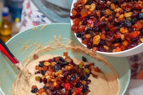 The process of making Easter cake, adding dried fruit to the dough, close-up, Stock-Fotos