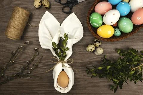The process of making Easter decorations. Easter eggs and willow twigs on a 库存照片