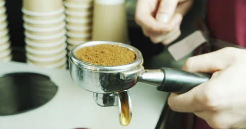 Process of making espresso in a coffee machine. Barista male hands making coffee Stock Footage 136328461
