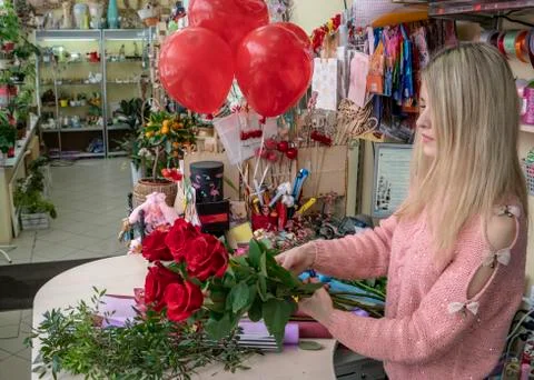 The process of making a festive bouquet girl florist. Stock Photos