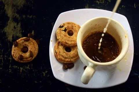 The process of making flat white coffee by pouring steam milk into a cup of e Stock Photos