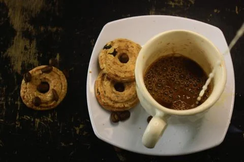 The process of making flat white coffee by pouring steam milk into a cup of e Stock Photos