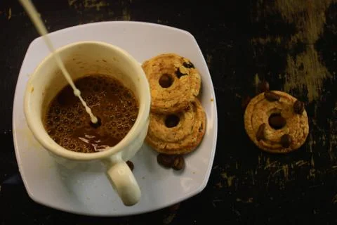 The process of making flat white coffee by pouring steam milk into a cup of e Stock Photos