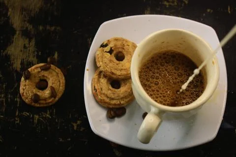 The process of making flat white coffee by pouring steam milk into a cup of e Stock Photos