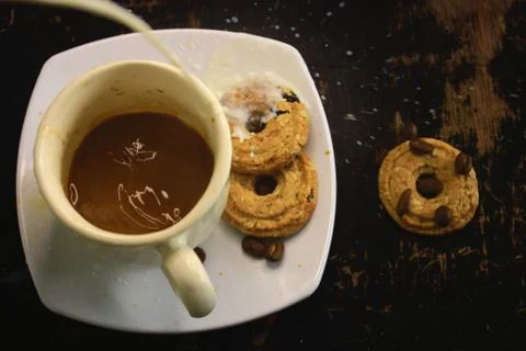The process of making flat white coffee by pouring steam milk into a cup of e Stock Photos