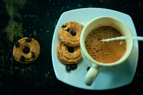 The process of making flat white coffee by pouring steam milk into a cup of e Stock Photos