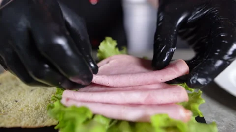 The process of making focaccia with turkey ham in the kitchen. Chef's hands lay Stock Footage 152694325