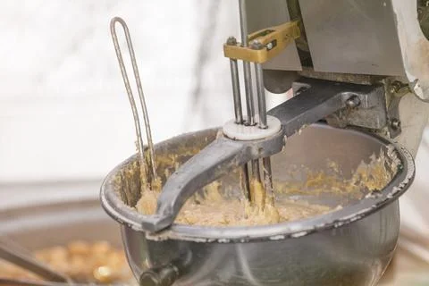 The process of making fresh cookies. Large industrial mixer close-up. She mixes Stock Photos