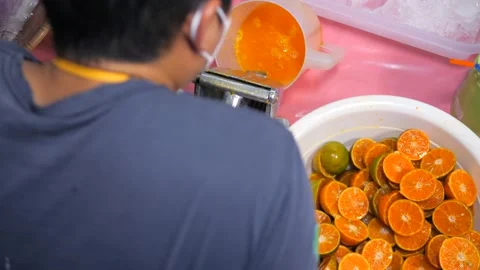 Process of Making Fresh Organic Mandarin Juice, Exotic Asian Street Food 4K Slow Stock Footage 234974021