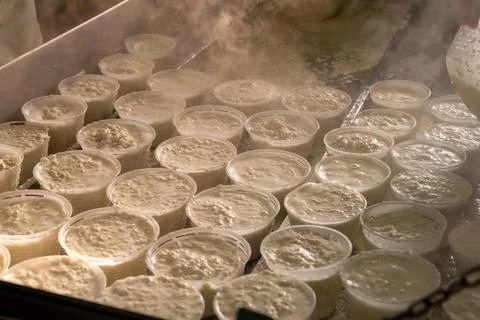 Process of making fresh white soft ricotta whey cheese on small cheese farm i Stock Photos
