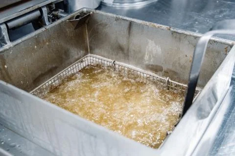Process of making fried chicken on the kitchen. Restaurant, cafe or pizzeria  Stock Photos