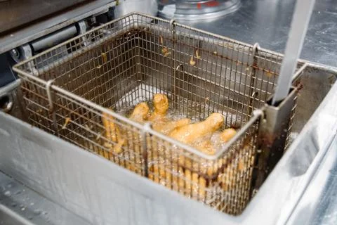 Process of making fried chicken on the kitchen. Restaurant, cafe or pizzeria  Stock Photos