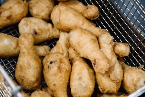 Process of making fried chicken on the kitchen. Restaurant, cafe or pizzeria  Stock Photos