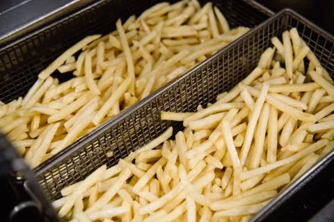 Process of making fried potato on the kitchen. Restaurant, cafe or pizzeria c Stock Photos