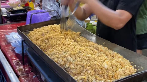 The process of making fried rice using a flat pan Stock Footage 259040008