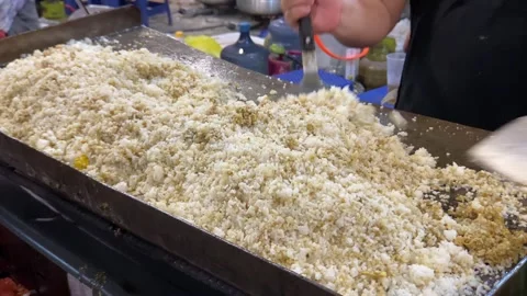 The process of making fried rice using a flat pan Stock Footage 259040397
