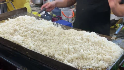 The process of making fried rice using a flat pan Stock Footage 259041659