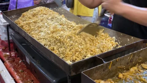 The process of making fried rice using a flat pan Stock Footage 259042213