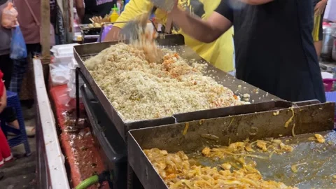 The process of making fried rice using a flat pan Stock Footage 259043566