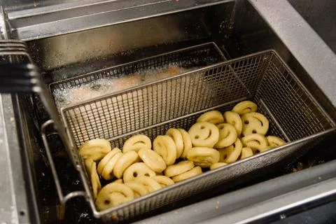 Process of making fried smile of potato on the kitchen. Restaurant, cafe or p Stock Photos