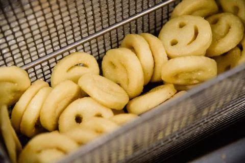 Process of making fried smile of potato on the kitchen. Restaurant, cafe or p Stock Photos