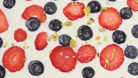 Process of making frozen yogurt bark with fruit. Sprinkling  with pistachios. Stock Footage 153459702