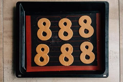 The process of making gingerbread for March 8. Cut out figure eights from dough Фото