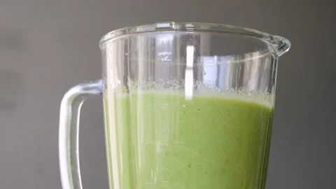The process of making a green vegetarian healthy smoothie: in the recipe spinach Stock Footage 178485743