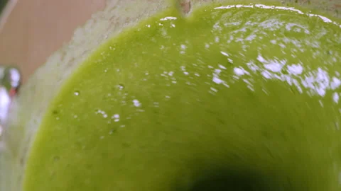 The process of making a green vegetarian healthy smoothie: in the recipe spinach Stock Footage 178485815