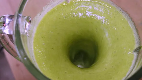 The process of making a green vegetarian healthy smoothie: in the recipe spinach Stock Footage 178485899