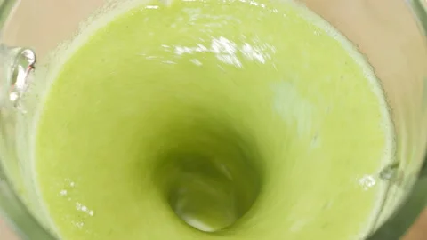 The process of making a green vegetarian healthy smoothie: in the recipe spinach Stock Footage 178486066