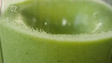 The process of making a green vegetarian healthy smoothie: in the recipe spinach Stock Footage 178486255