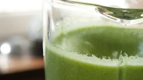 The process of making a green vegetarian healthy smoothie: in the recipe spinach Stock Footage 178486427