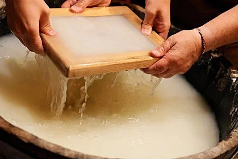 The process of making handmade paper. Traditional papermaking workshop. Stock Photos