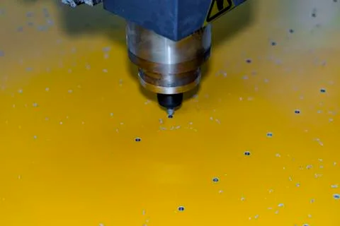 The process of making holes in a plastic. Stock Photos