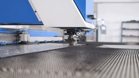 The process of making holes in a sheet of metal on a specialized machine Stock Footage 88588834
