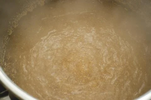 Process of making home beer from malt. Craft beer from barley and dark malt. Stock Photos