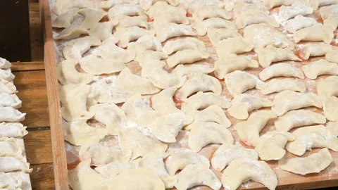 The process of making home-made dumplings. Raw homemade dumplings on a wooden Stock Footage 98268054