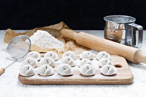 The process of making home-made dumplings. Raw homemade dumplings on a wooden Stock Photos