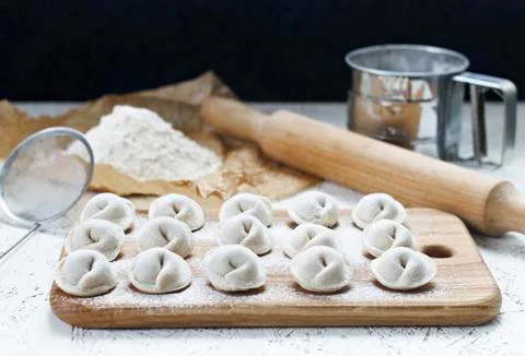 The process of making home-made dumplings. Raw homemade dumplings on a wooden Stock Photos
