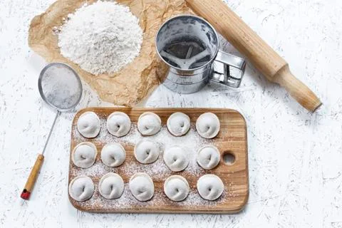 The process of making home-made dumplings. Raw homemade dumplings on a wooden Stock Photos