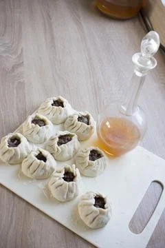 The process of making home-made dumplings. Raw homemade dumplings on a wooden Stock Photos