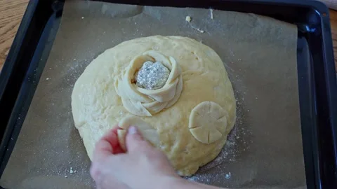 The process making homemade bread. baker decorate bread festive loaf dough Stock Footage 202287170