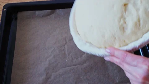 The process making homemade bread. Place yeast dough from rattan proofing basket Stock Footage 181594807